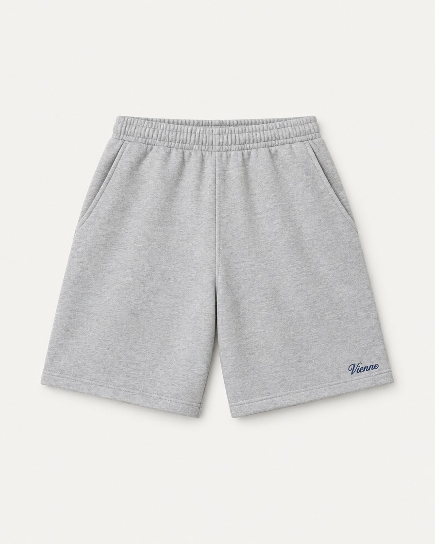 Concept render: heather grey fleece shorts with a small navy Vienne script near the hem
