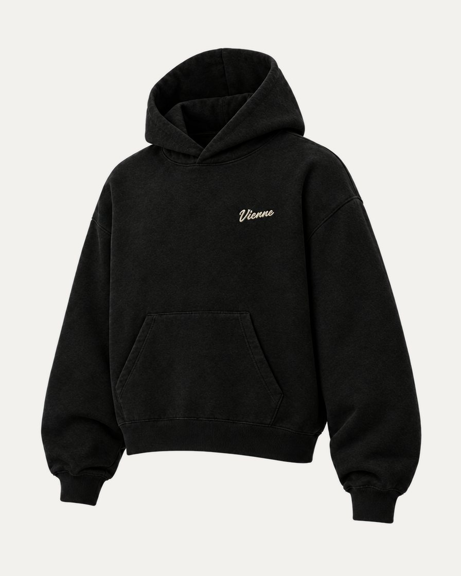 Concept image: black Signé Hoodie with a cream Vienne script, three quarter view