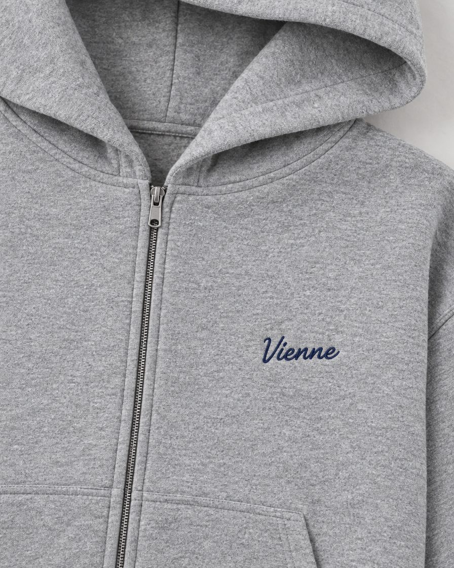 Concept image: heather grey Signé Zip Hoodie, close up of the front