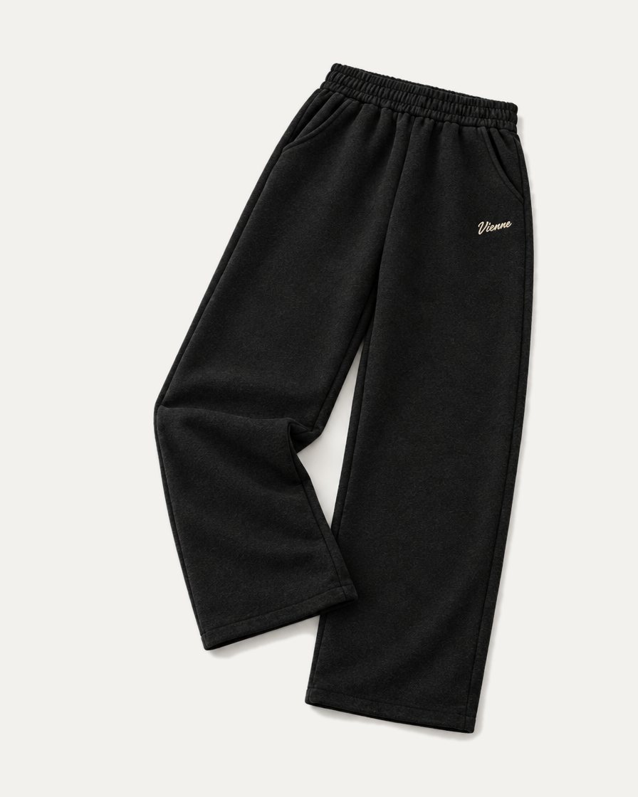 Concept image: black Signé Sweatpant laid at an angle, wide straight leg