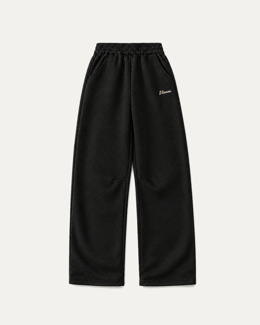 Concept image: black Signé Sweatpant with a small cream Vienne script on the thigh, front