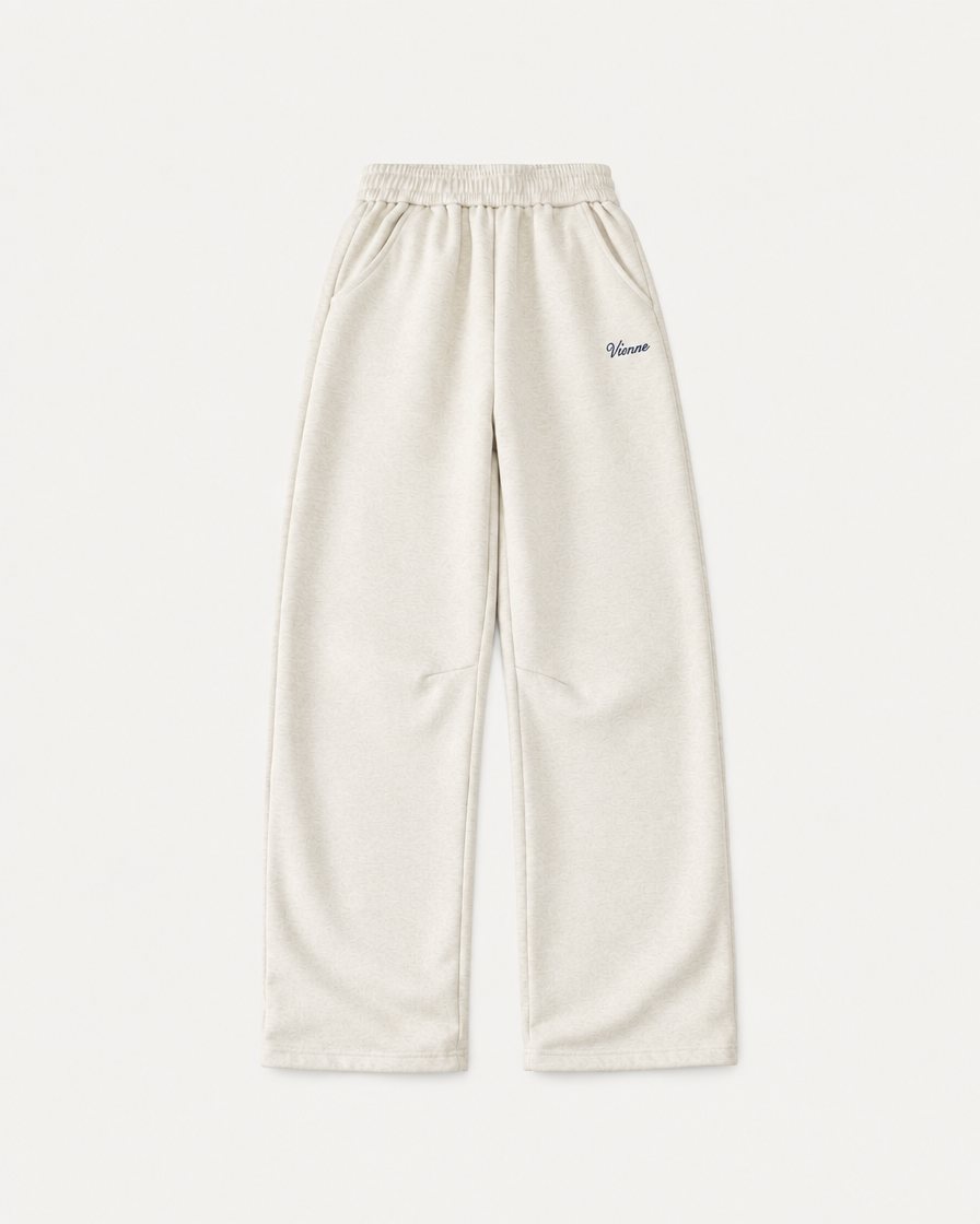 Concept render: cream wide leg sweatpants with a small Vienne script on the thigh