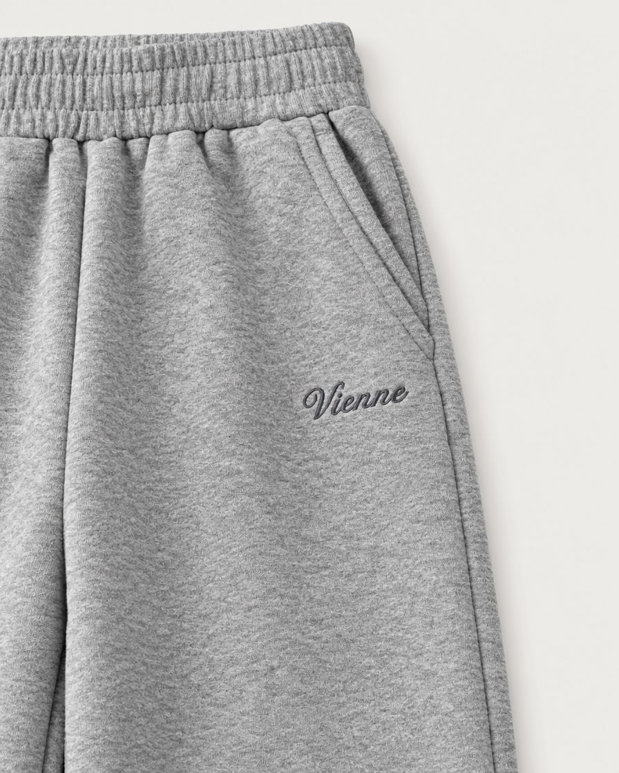 Concept image: close up of the elastic waist, slant pocket and Vienne script on the heather grey Bonbon Sweatpant
