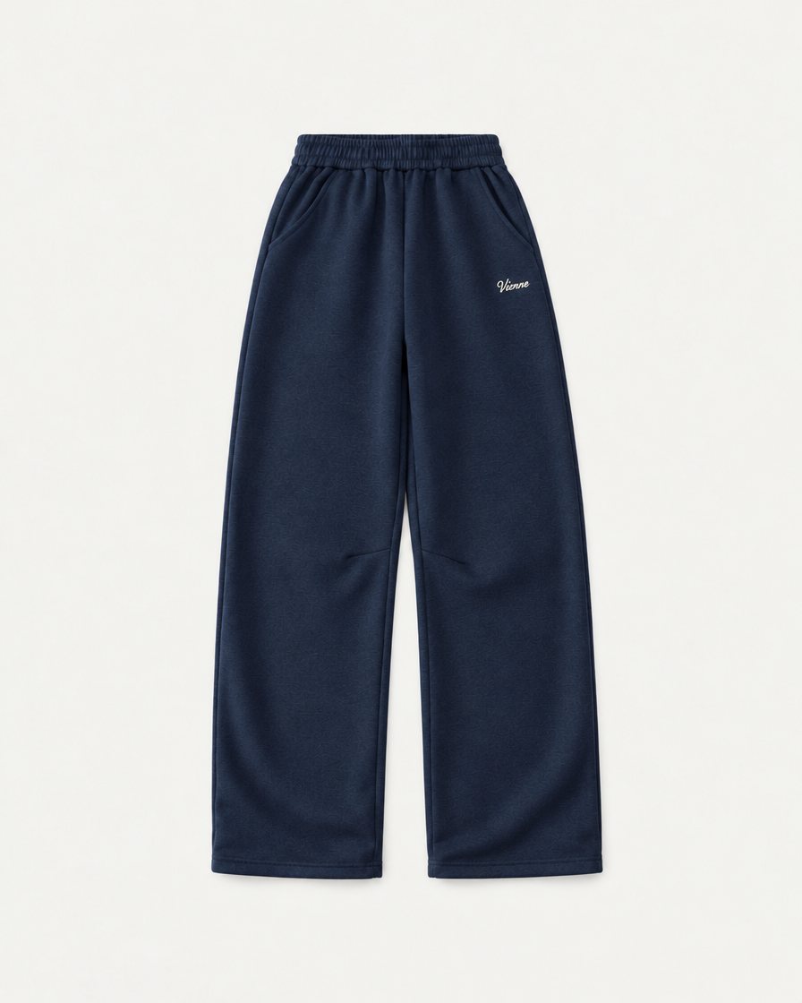 Concept render: navy wide leg sweatpants with a small Vienne script on the thigh